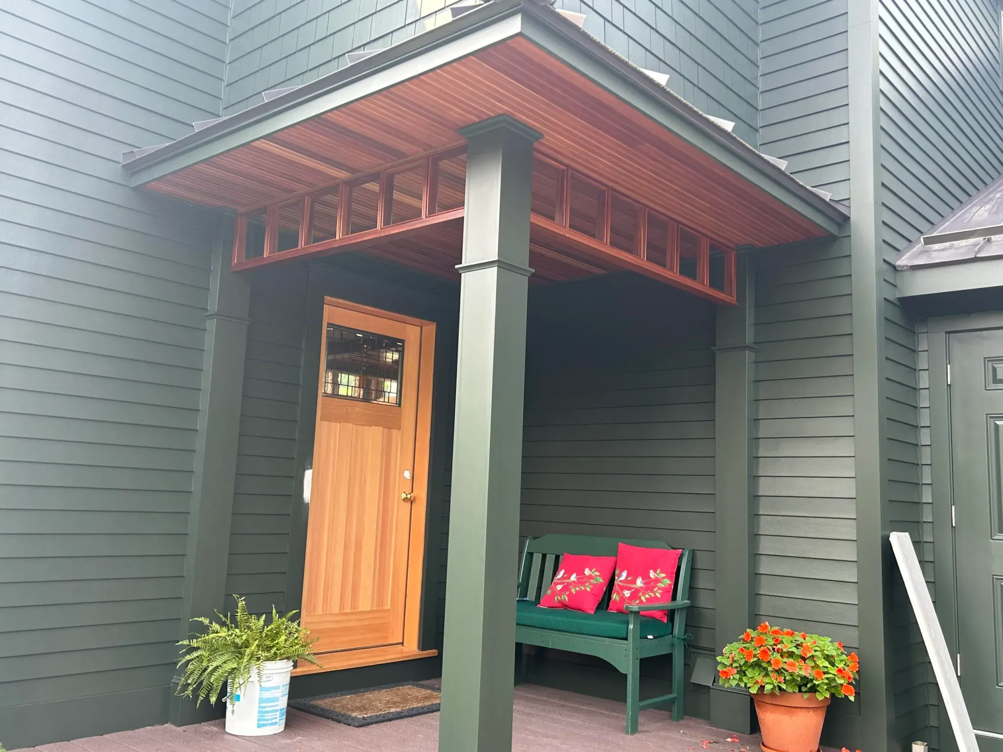Custom entry portico with cedar plank ceiling