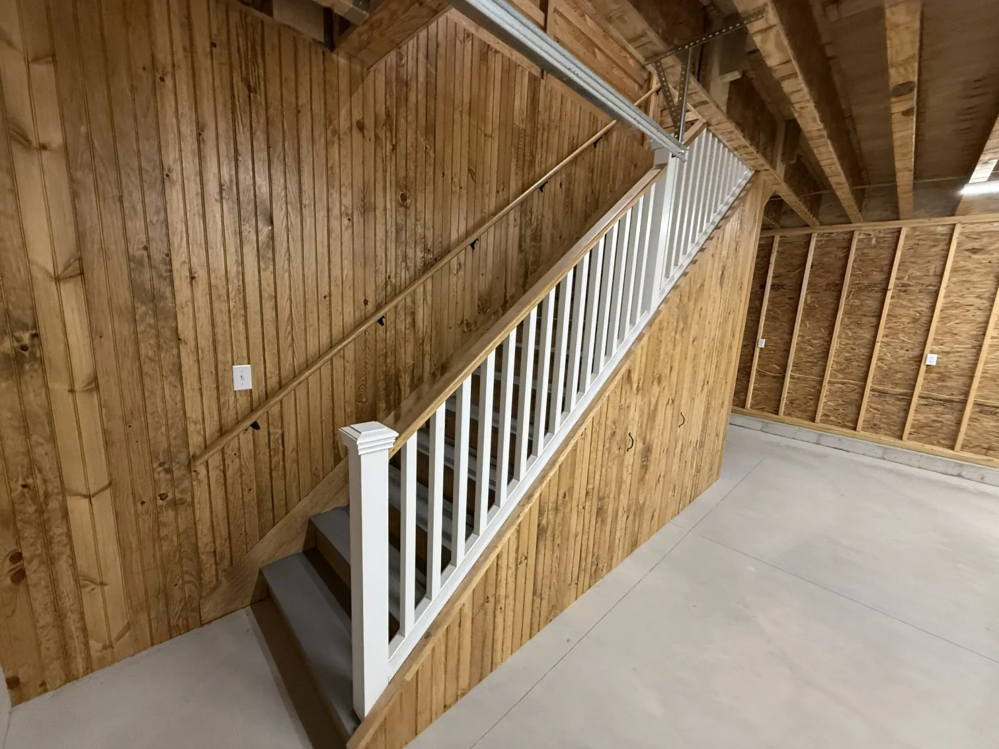 Finished staircase in a custom garage interior