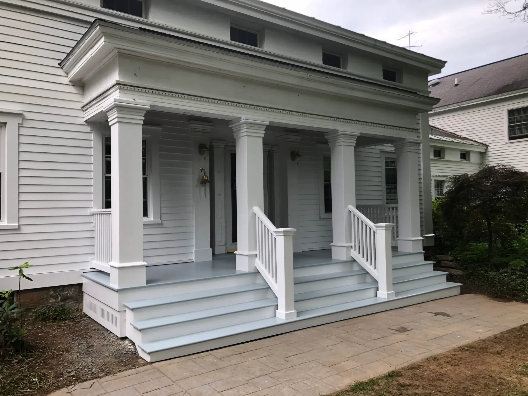 Greek Revival style porch addition with columns
