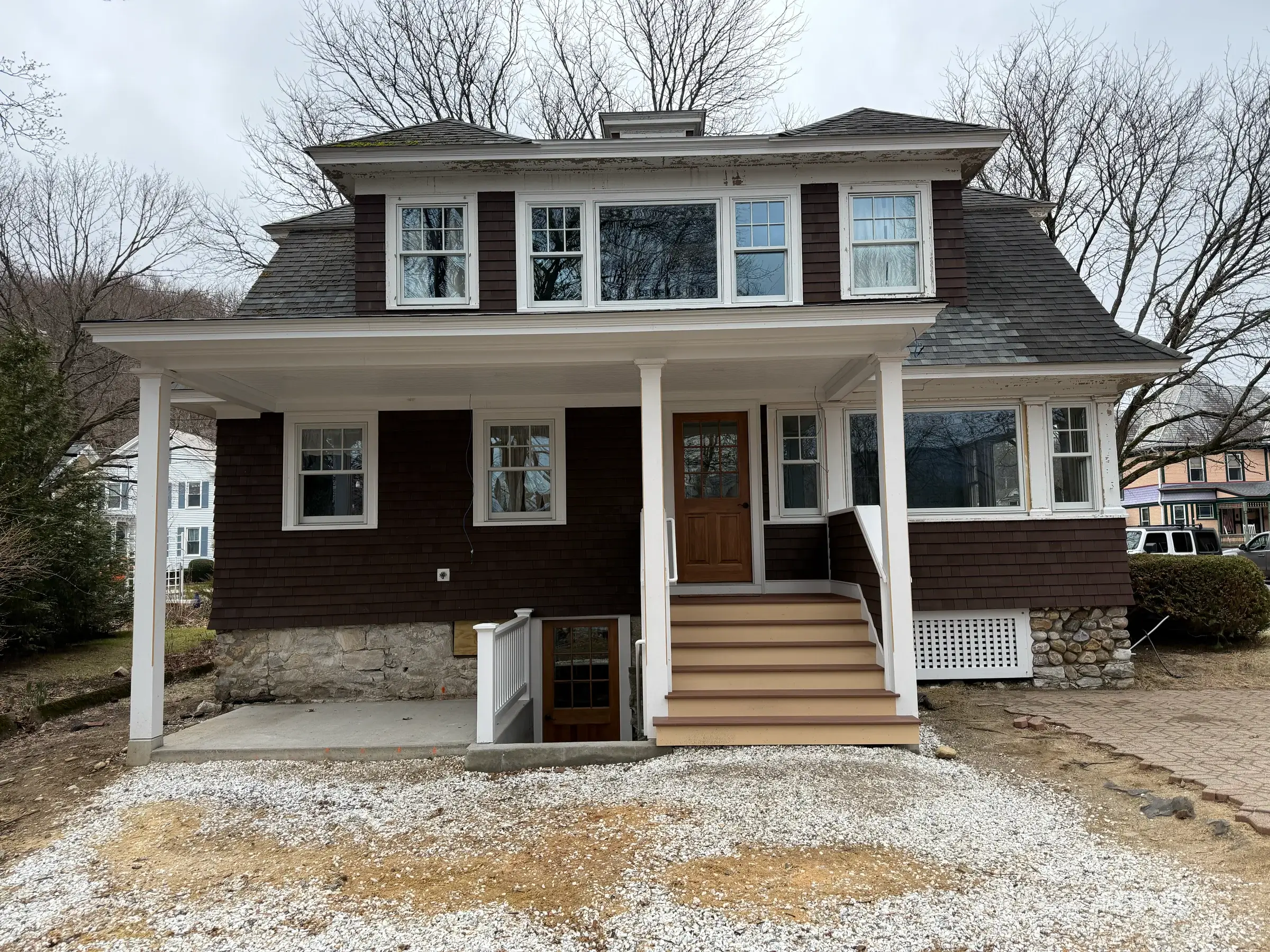 Shingle-style Victorian home with wraparound farmer's porch