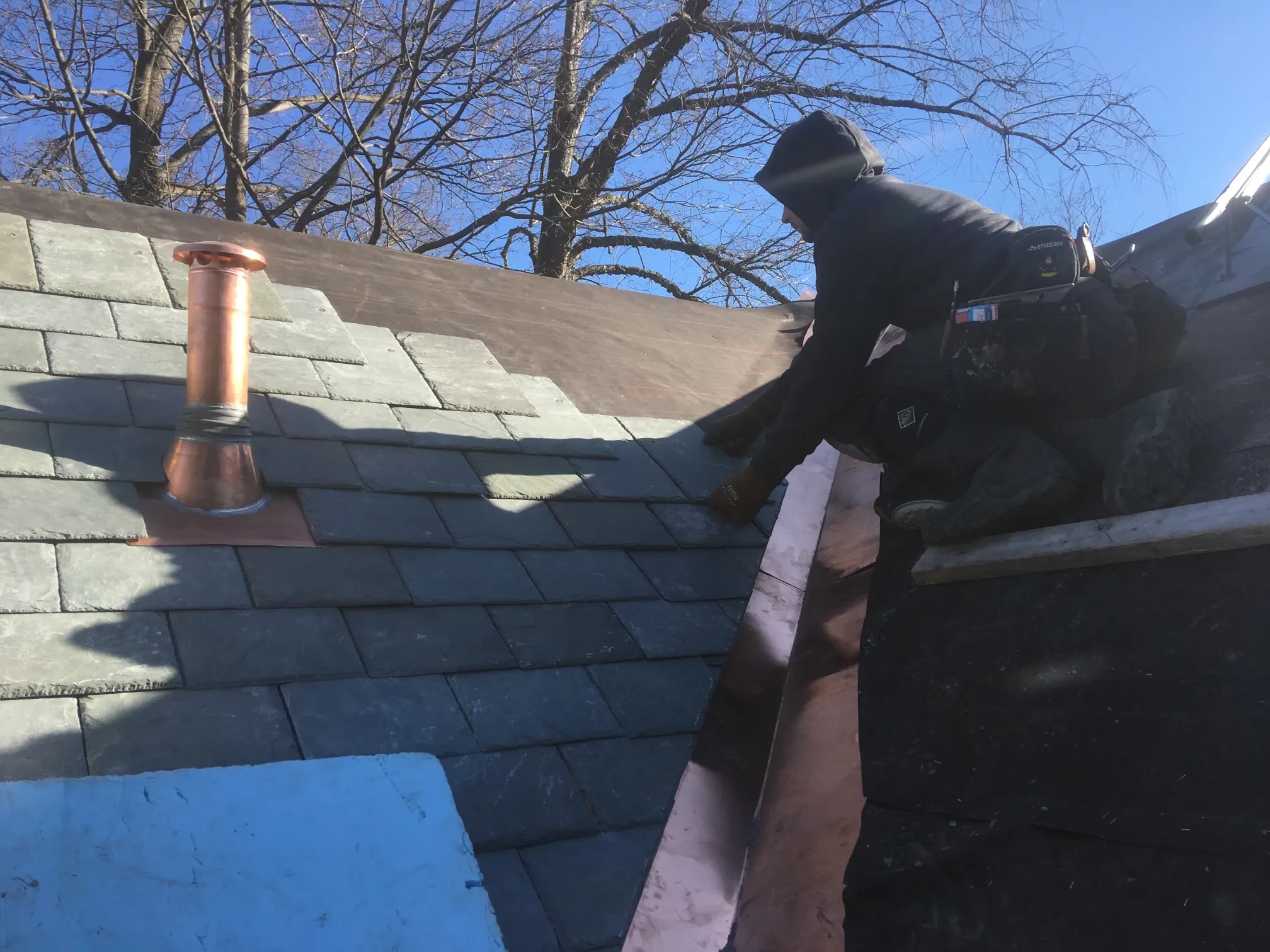 Slate roof installation with copper flashing