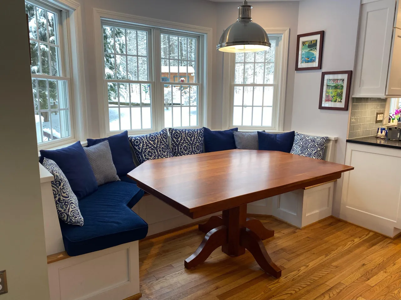 Custom built-in dining banquette with navy cushions, built by Burnham Custom Building and Remodeling