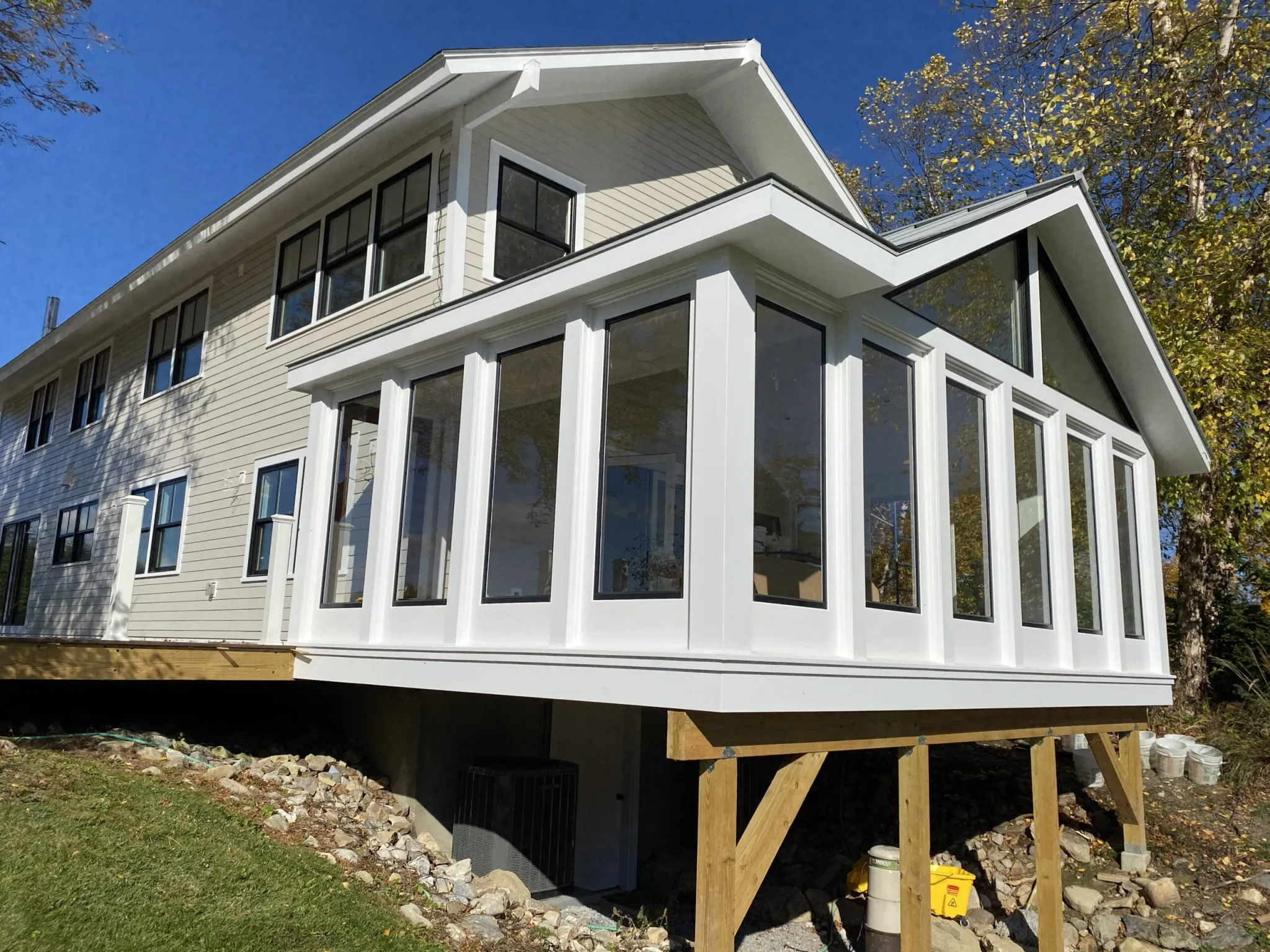 Glass-walled great room addition with vaulted gable, built by Burnham Custom Building and Remodeling in Berkshire County, MA